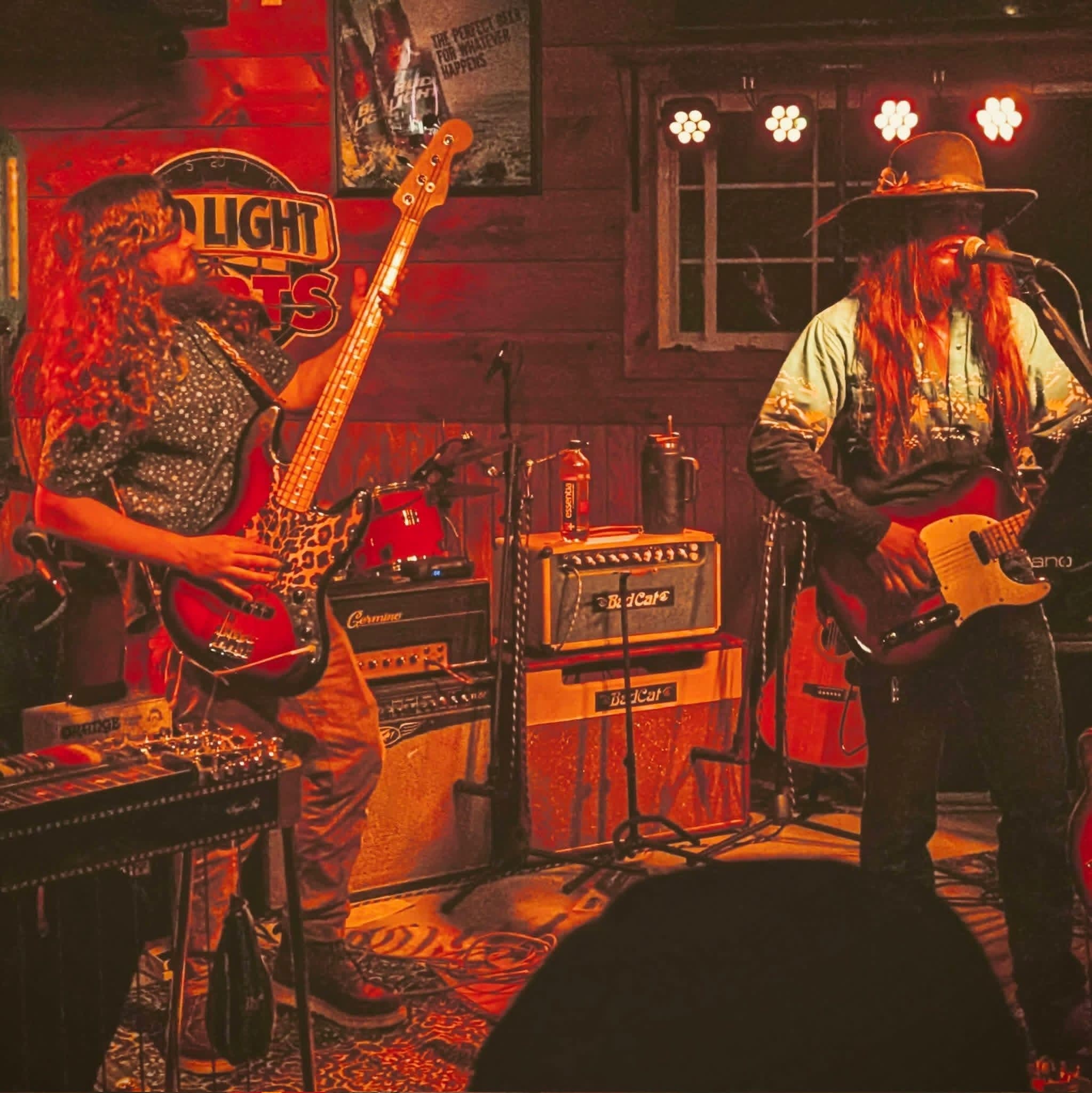 Full band performing under a Bud Light sign